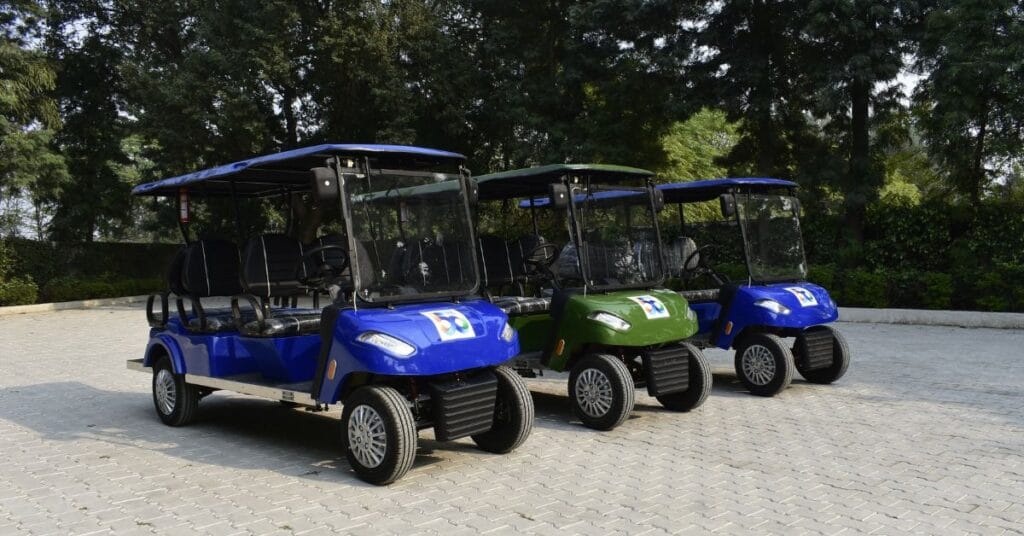 2 blue and one green electric golf cart is a feature image for blog named electric golf cart maintenance tips